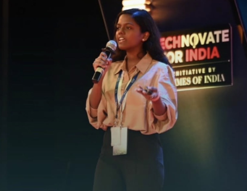 Krithika speaking on stage